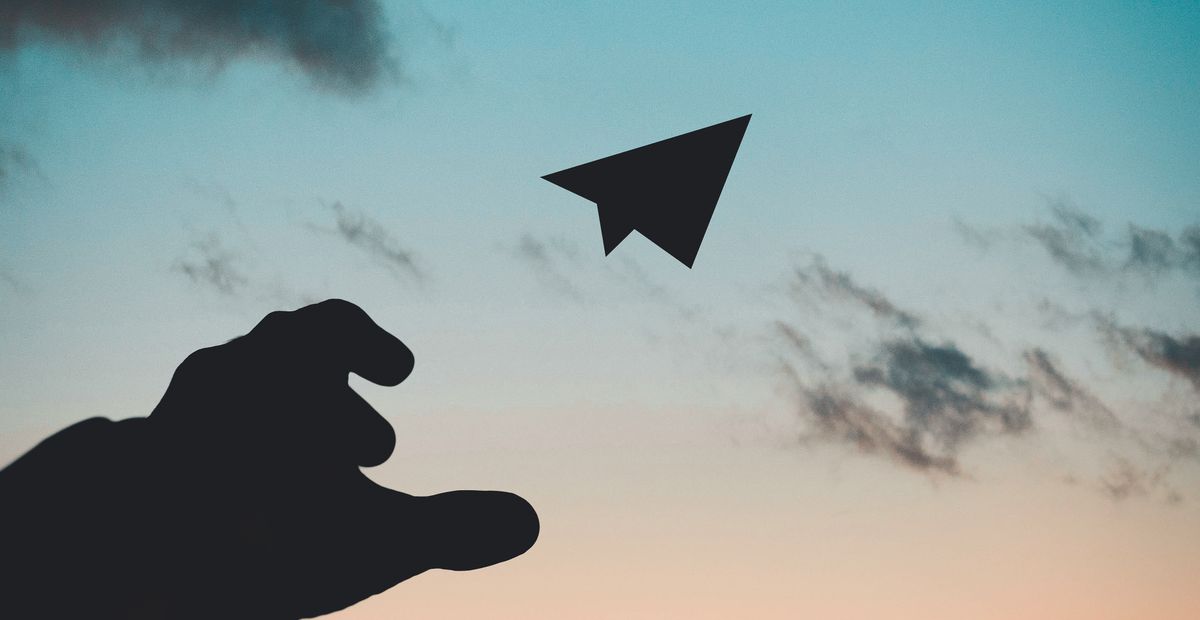 A folded paper dart airplane